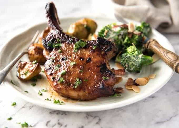 Oven Baked Pork Chops - Slathered in a tasty rub made with pantry ingredients, then baked to perfection. Add some potatoes and veggies for a one sheet pan meal! recipetineats.com