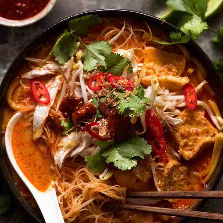 Overhead photo of Laksa in a rustic bowl, ready to be eaten.