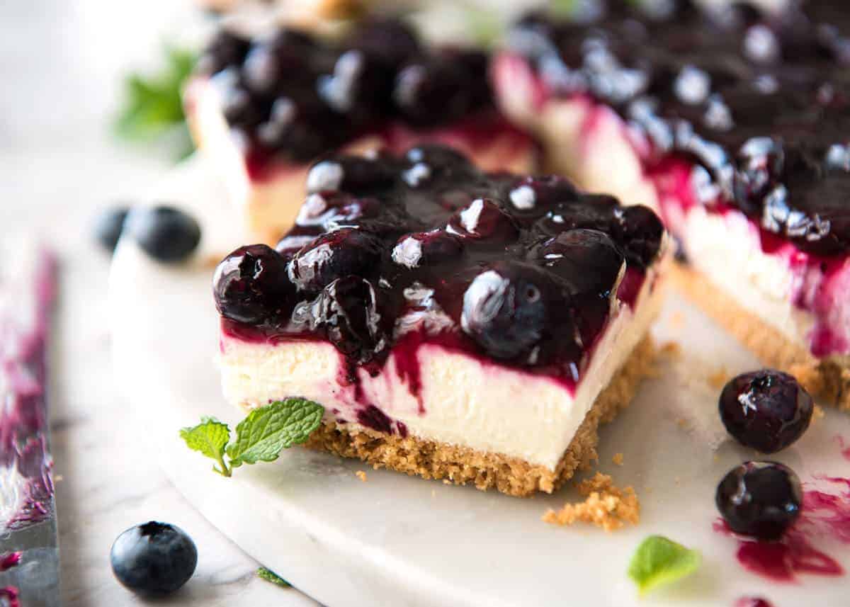 Easy and fast No Bake Blueberry Cheesecake Bars - creamy cheesecake with a gorgeous fresh blueberry sauce topping! www.recipetineats.com