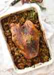 This Cajun dry brined turkey breast is baked in the same roasting pan as the Dressing / Stuffing so it's extra juicy and moist! A chef recipe, this Cajun Baked Turkey Breast with Dressing is easy and spectacular. EPIC ONE PAN COOKING for a Thanksgiving turkey! recipetineats.com