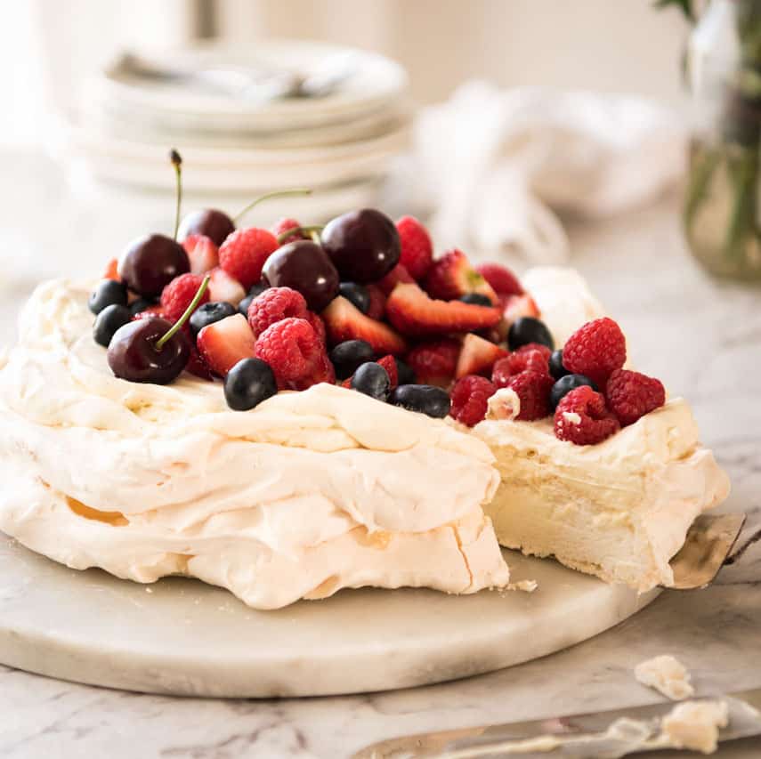 Pavlova on a white marble serving platter, ready to be served