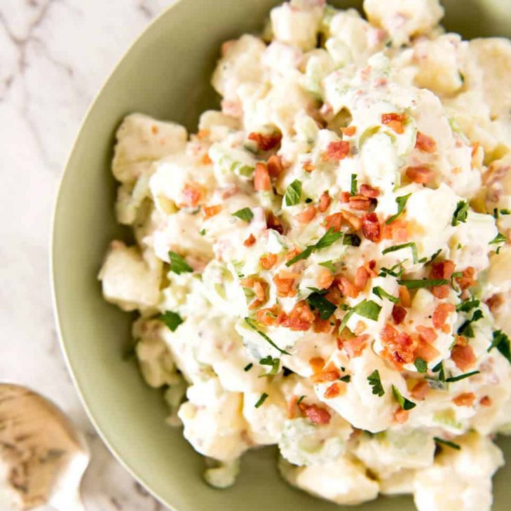 A classic potato salad made epic by pouring French dressing over the potatoes while cooked so it absorbs the flavour. The BEST potato salad I've ever had! www.recipetineats.com