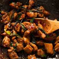 Close up of Thai Basil Chicken in a wok, fresh off the stove ready to be served