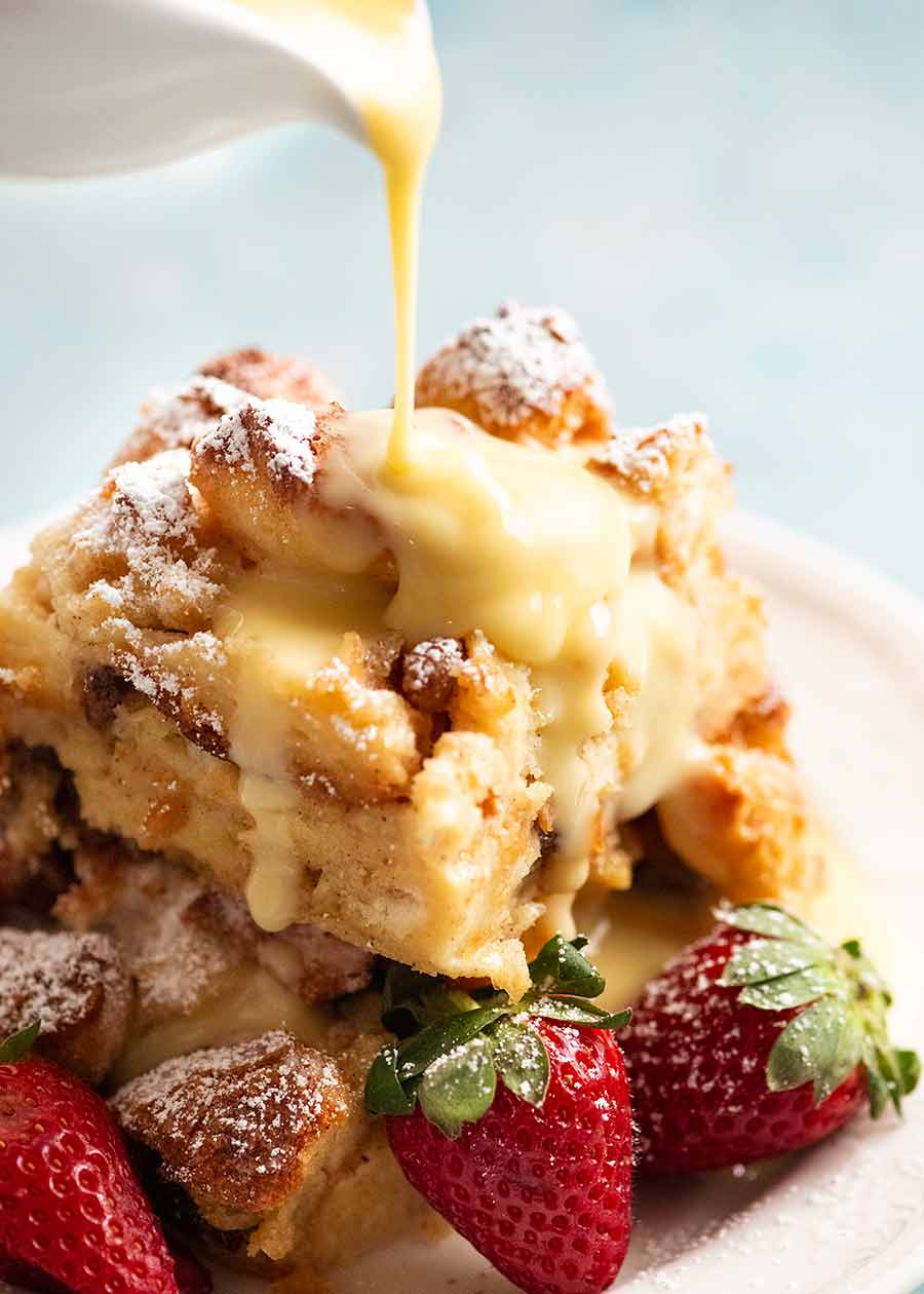 Pouring custard over Bread and Butter Pudding