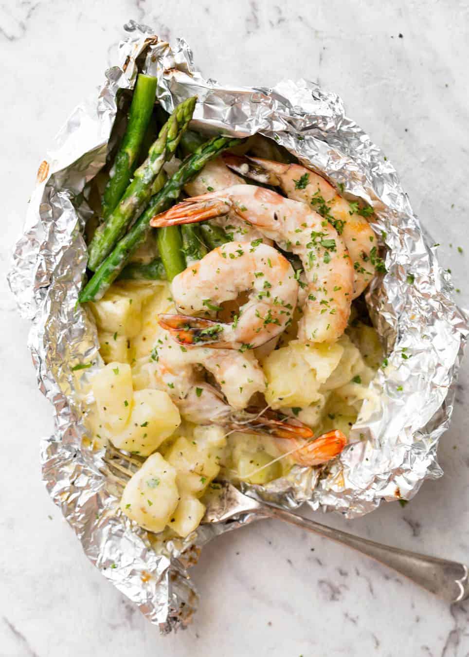 Creamy Garlic Shrimp, Cheesy Potatoes and asparagus - serious contender for the BEST foil packet recipe ever! recipetineats.com