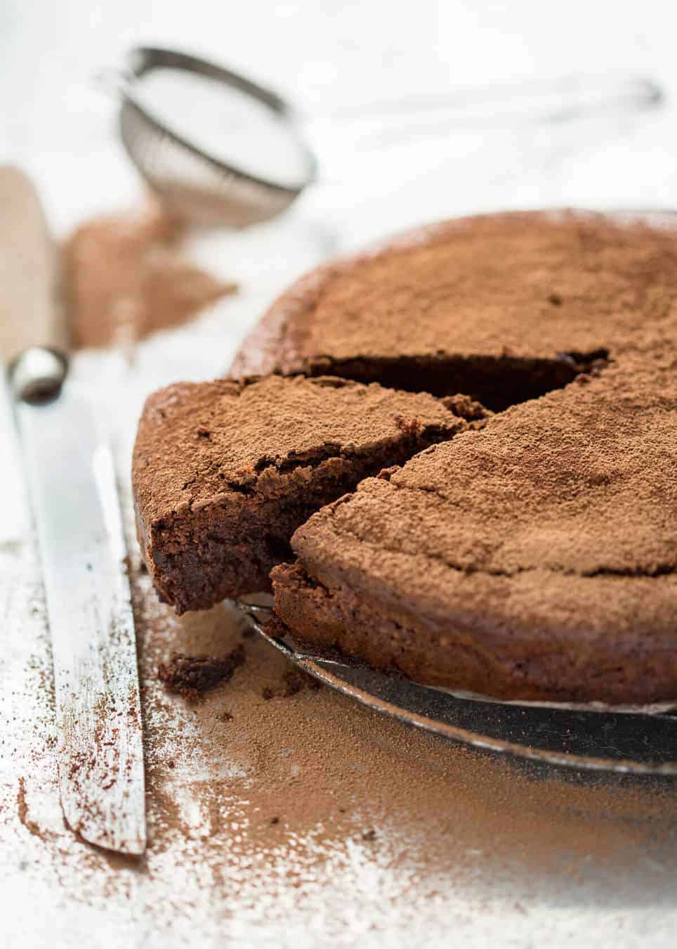 A simple Flourless Chocolate Cake made with almond meal / almond flour. Moist inside, with a thin crackly brownie-like surface. A stunning, very quick cake to make! www.recipetineats.com