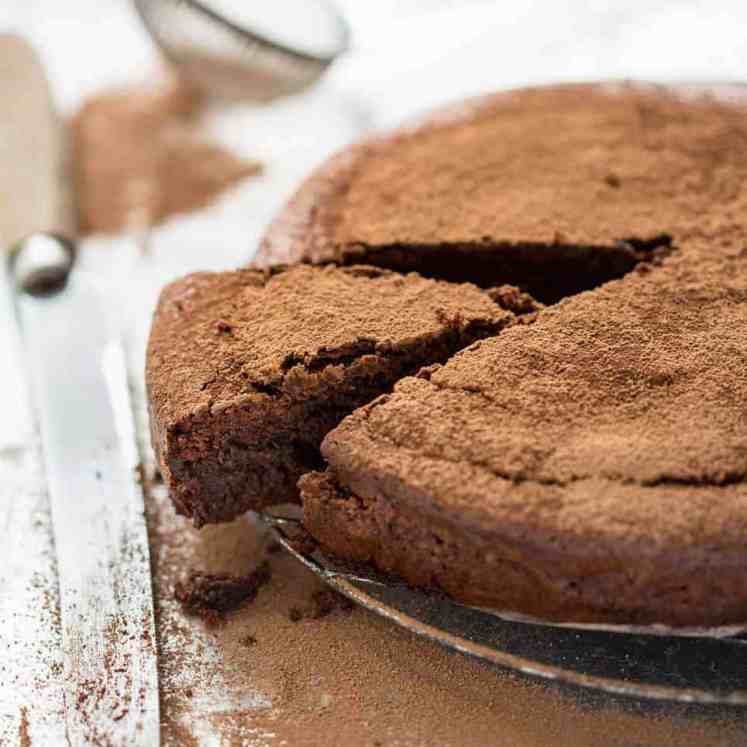 A simple Flourless Chocolate Cake made with almond meal / almond flour. Moist inside, with a thin crackly brownie-like surface. A stunning, very quick cake to make! recipetineats.com