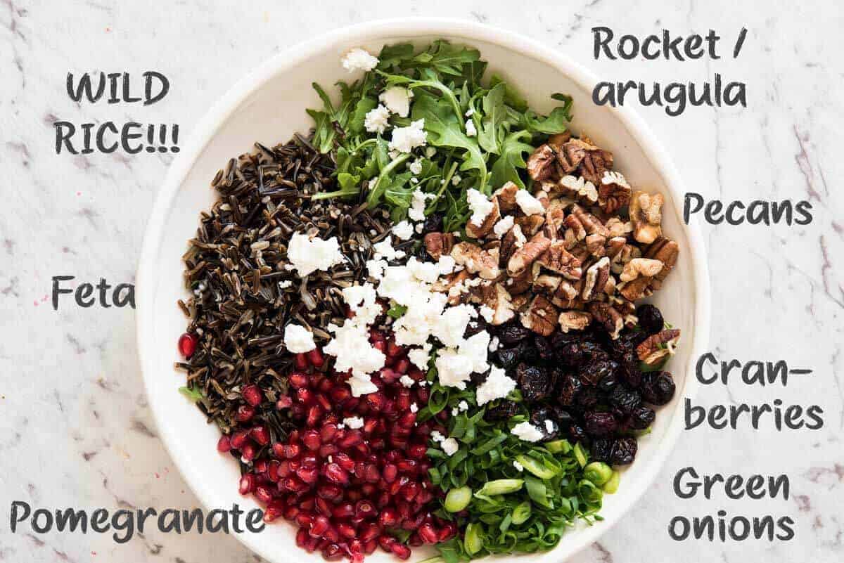 This Wild Rice Salad is a salad for celebrations! Stellar flavour combination - wild rice, pomegranate, pecans, rocket / arugula, green onions, cranberries and feta. www.recipetineats.com