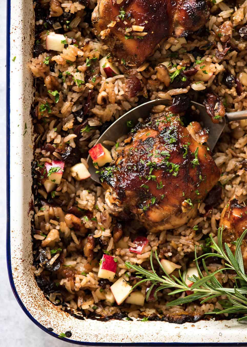 A flavour loaded one-pan, quick midweek dinner - Baked Chicken and Rice Pilaf with Cranberries, Walnuts and Apple. The smell when this is cooking is amazing! recipetineats.com