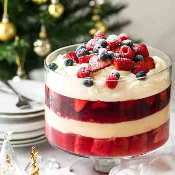 Layers of Cranberry Jelly and custard, and piled high with whipped cream and fruit, this Christmas Trifle will brighten any table! recipetineats.com
