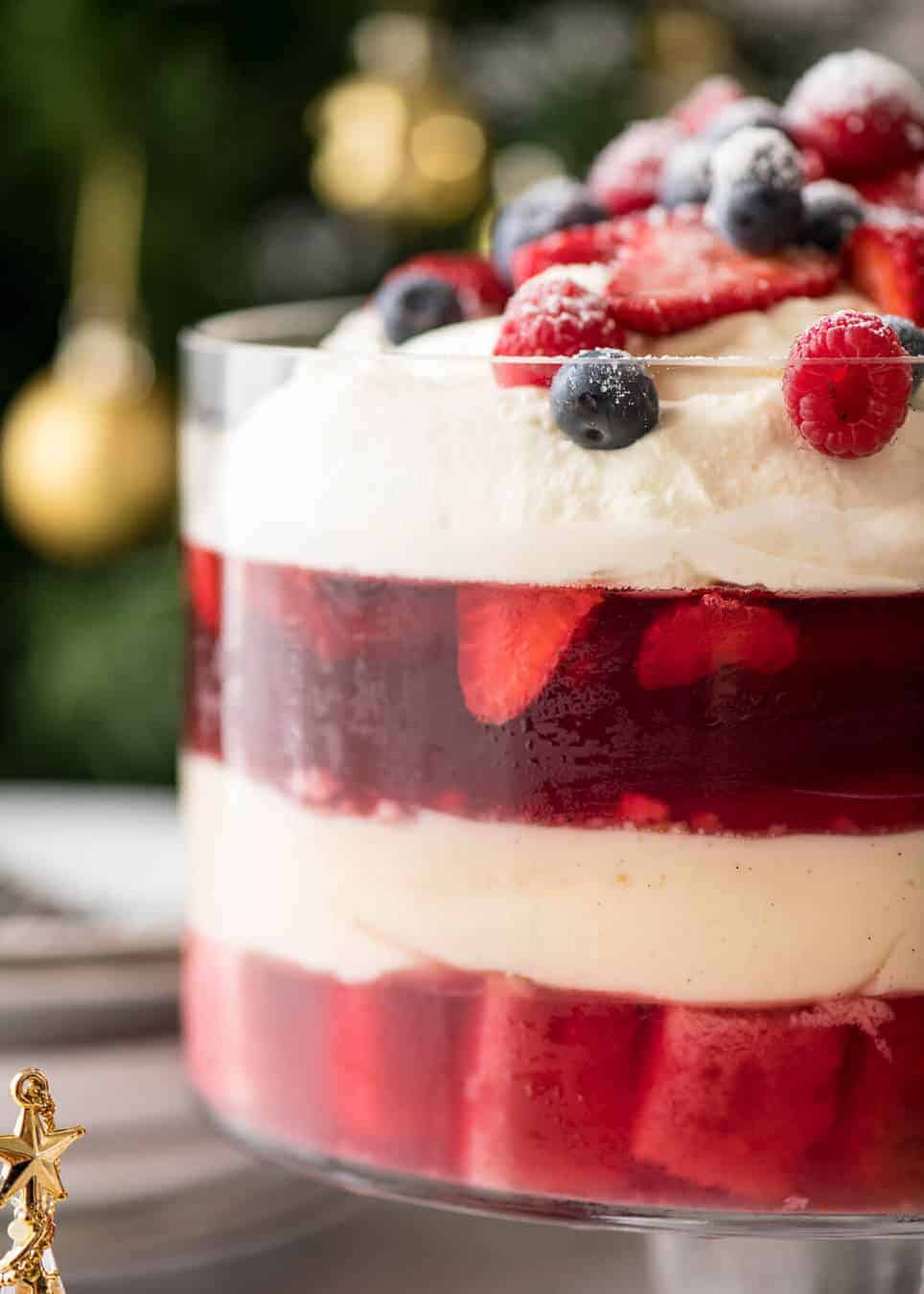 Layers of Cranberry Jelly and custard, and piled high with whipped cream and fruit, this Christmas Trifle will brighten any table! recipetineats.com