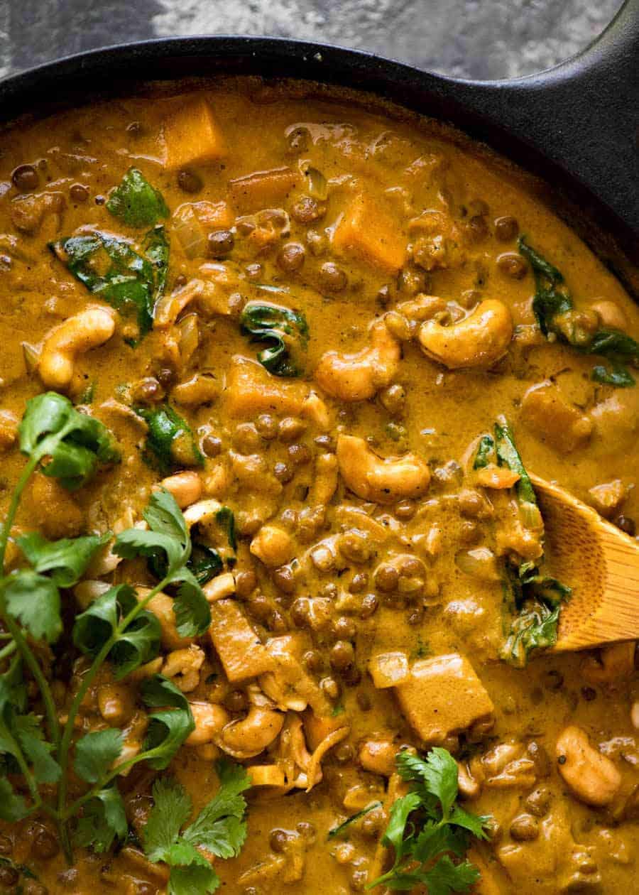 Close up of Coconut Curry with Lentils & Pumpkin in a black skillet