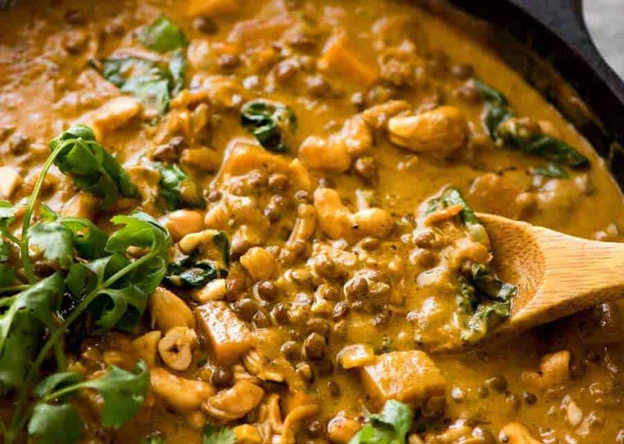 Close up of Coconut Curry with Lentils & Pumpkin in a black skillet