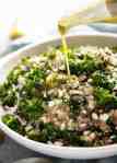 Pouring Lemon Dressing over Kale and Quinoa Salad
