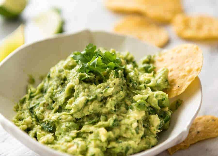 Authentic Mexican Guacamole in a small rustic white bowl