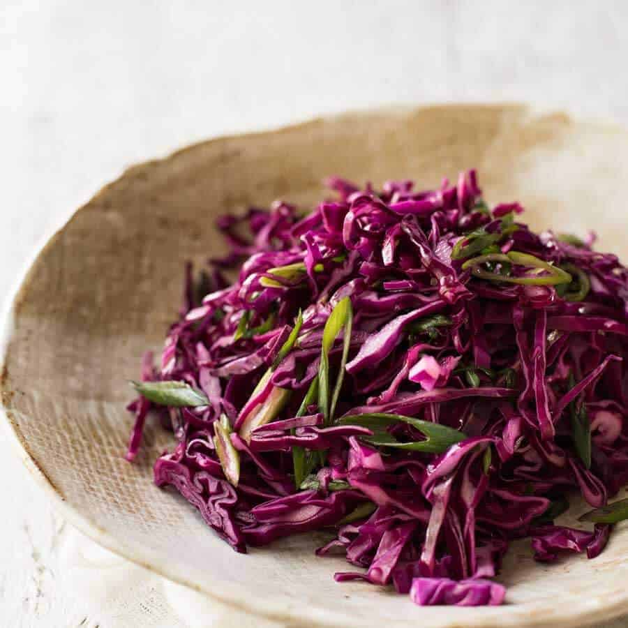 Quick pickled red cabbage - great side for a Mexican menu - in a rustic brown bowl.