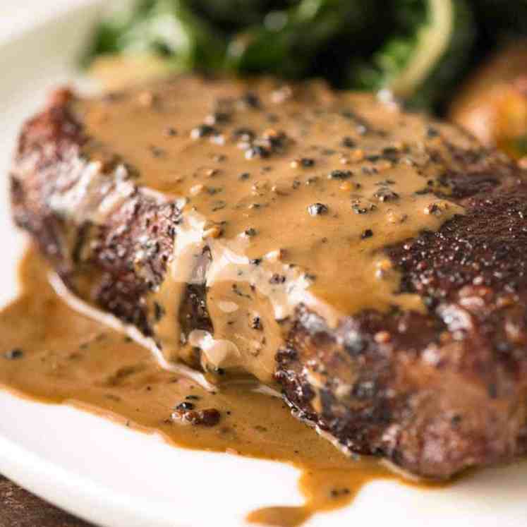 Close up of Creamy Peppercorn Sauce dripping down the side of steak