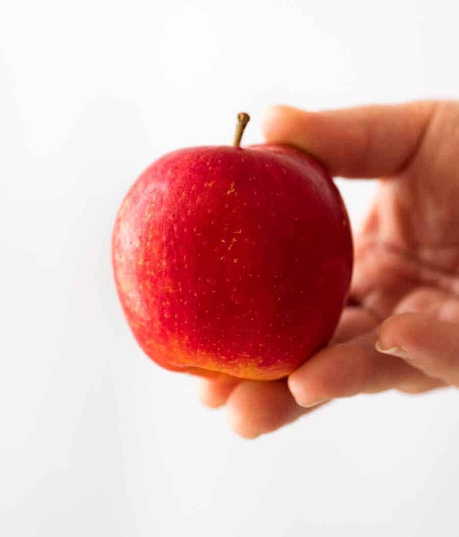 Hand holding red Modi Apple