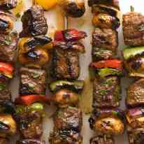 Overhead photo of Marinated Beef Kabobs with bell peppers, mushrooms and red onion
