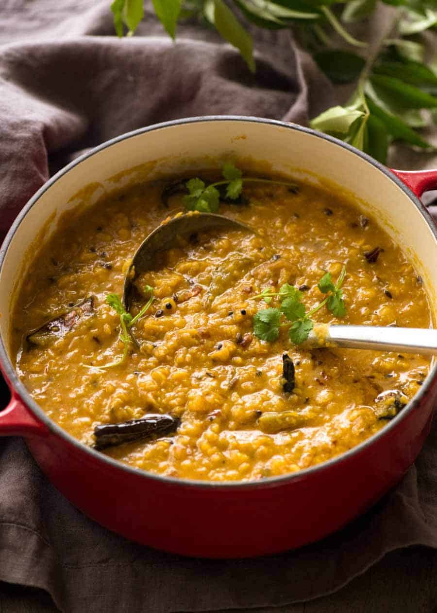 Homemade Dal in a red cast iron pot, fresh off the stove ready to be served.