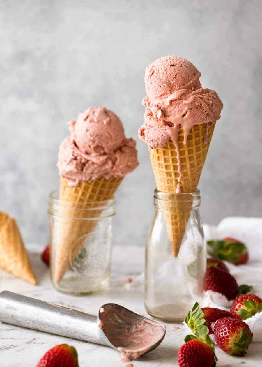 Creamy No Churn Strawberry Ice Cream in waffle cones, ready to be eaten!
