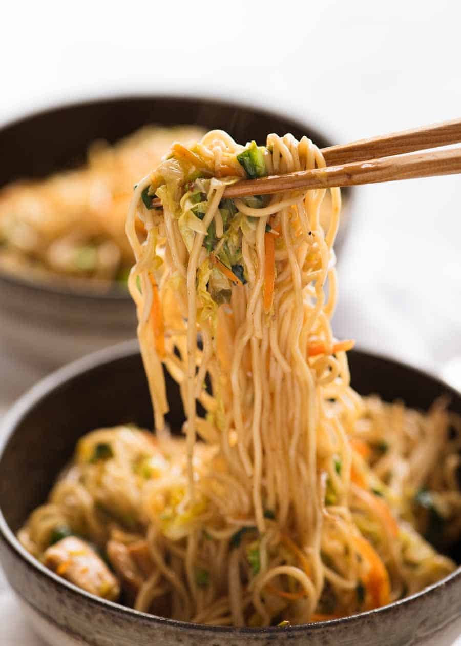 Chopsticks picking up Chow Mein noodles