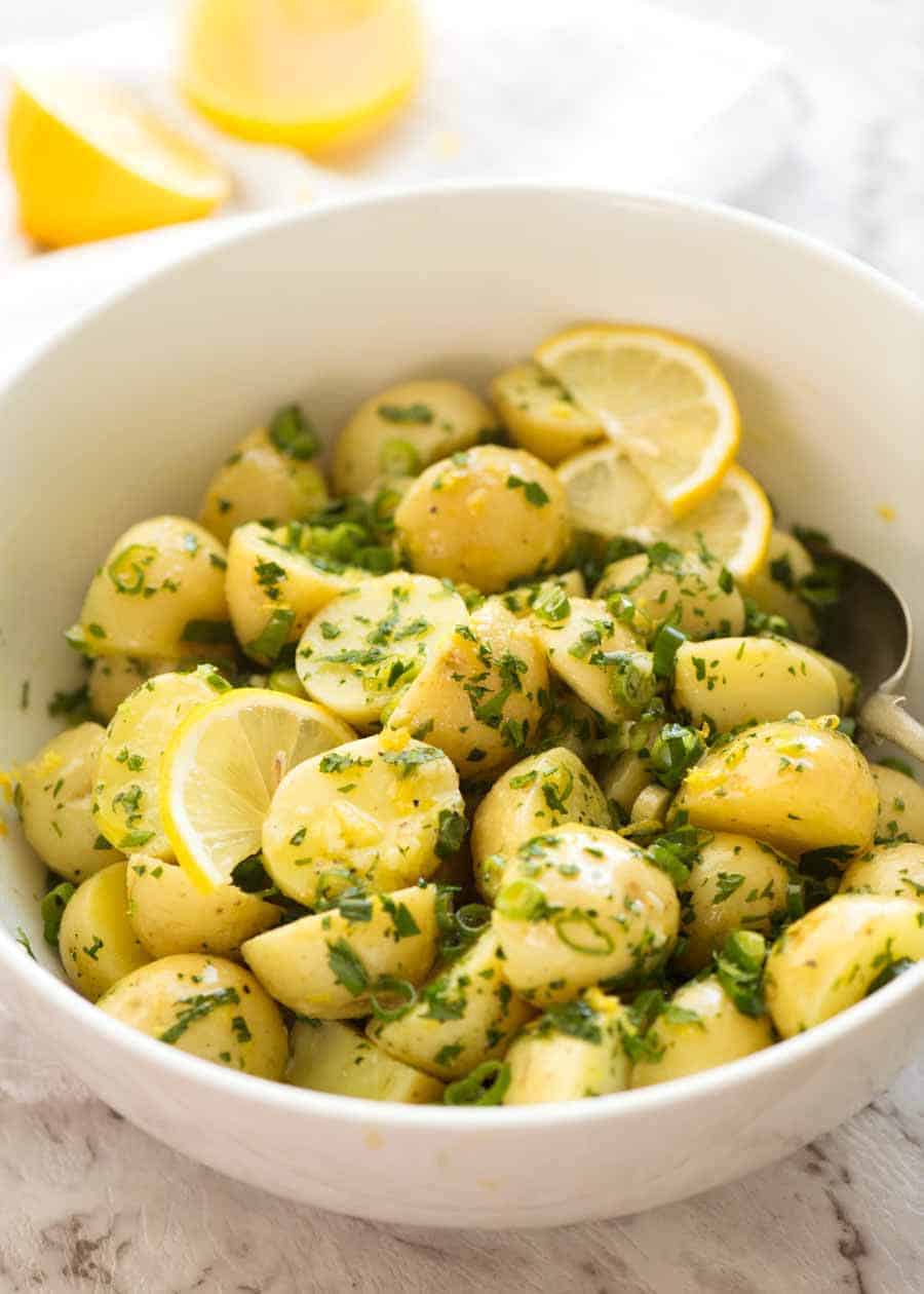Lemon Potato Salad with no mayo in a white bowl, ready to be served