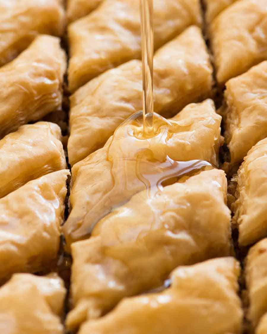 Pouring syrup over Baklava