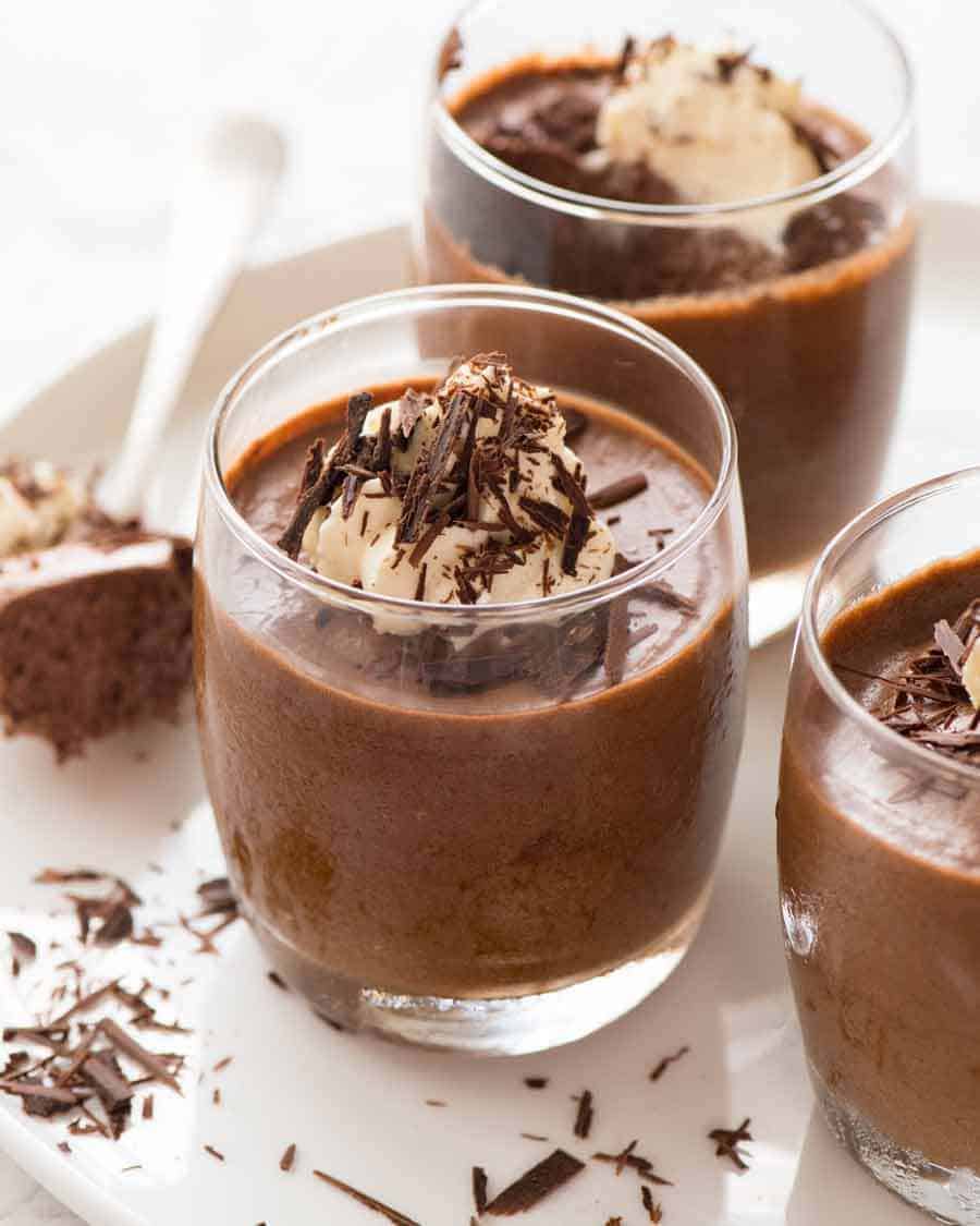 Mousse de Chocolate em copos cobertos com um montão de creme e aparas de chocolate, pronto para ser servido