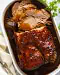 Slow Cooker Pork Loin Roast in a white dish, ready to be served