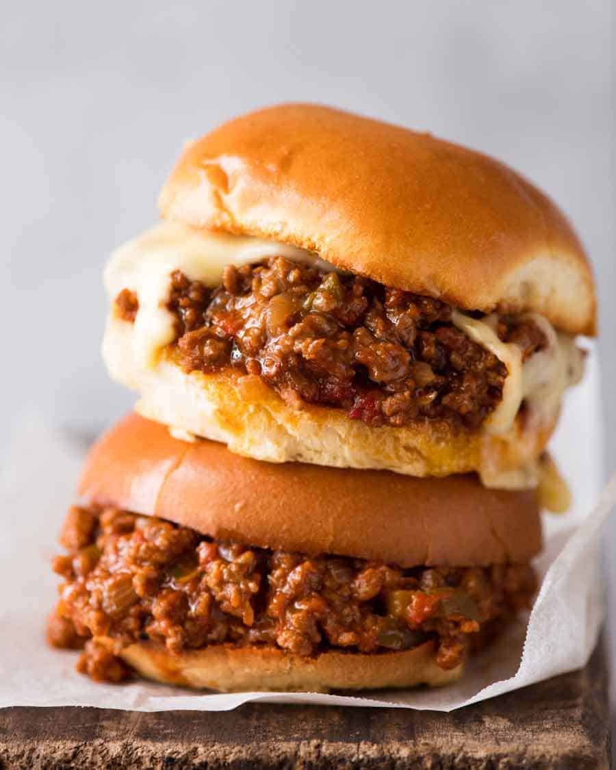 2 Sloppy Joes stacked on top of each other, one with melted cheese, ready to be eaten