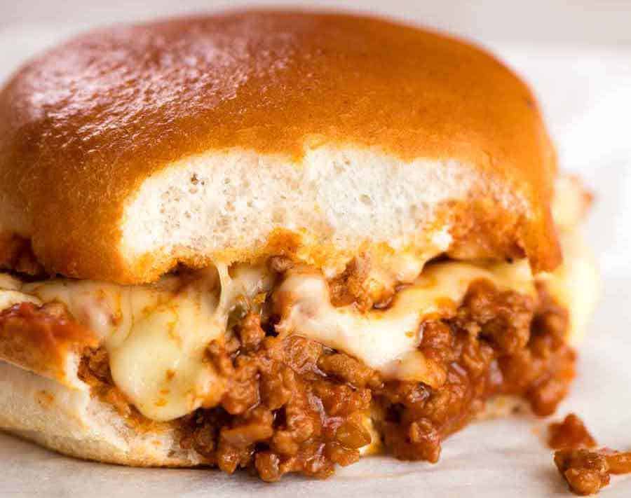 Close up of Sloppy Joe with cheese with bite take out of it