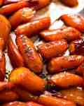Close up of Brown Sugar Glazed Carrots on a tray, fresh out of the oven