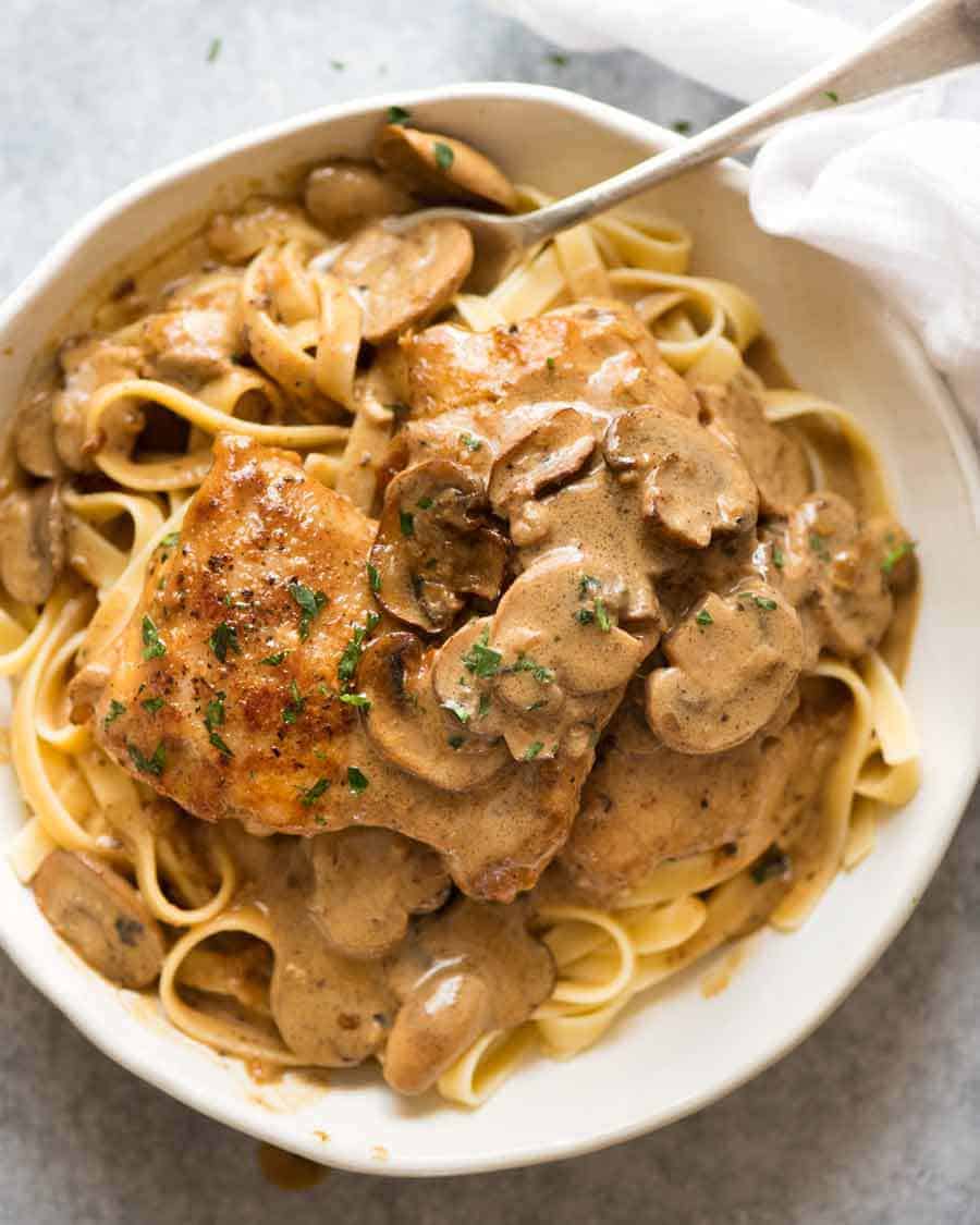 Overhead shot of Chicken Stroganoff in a white bowl, ready to eat