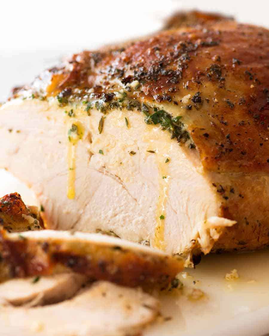 Sliced Garlic Herb Slow Cooker Turkey Breast with butter dripping down