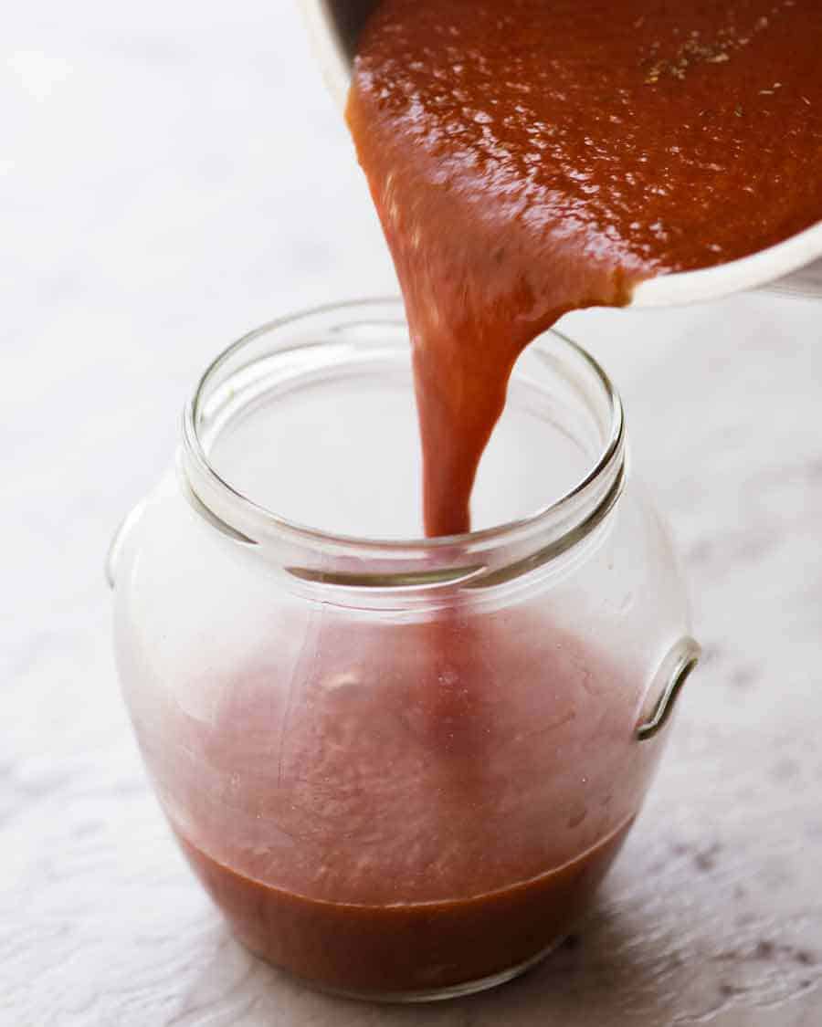 Taco Sauce being poured into a jar