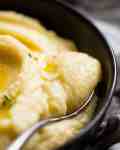 Close up of Paris Mash (Rich & Creamy Mashed Potato) being scooped up with a spoon