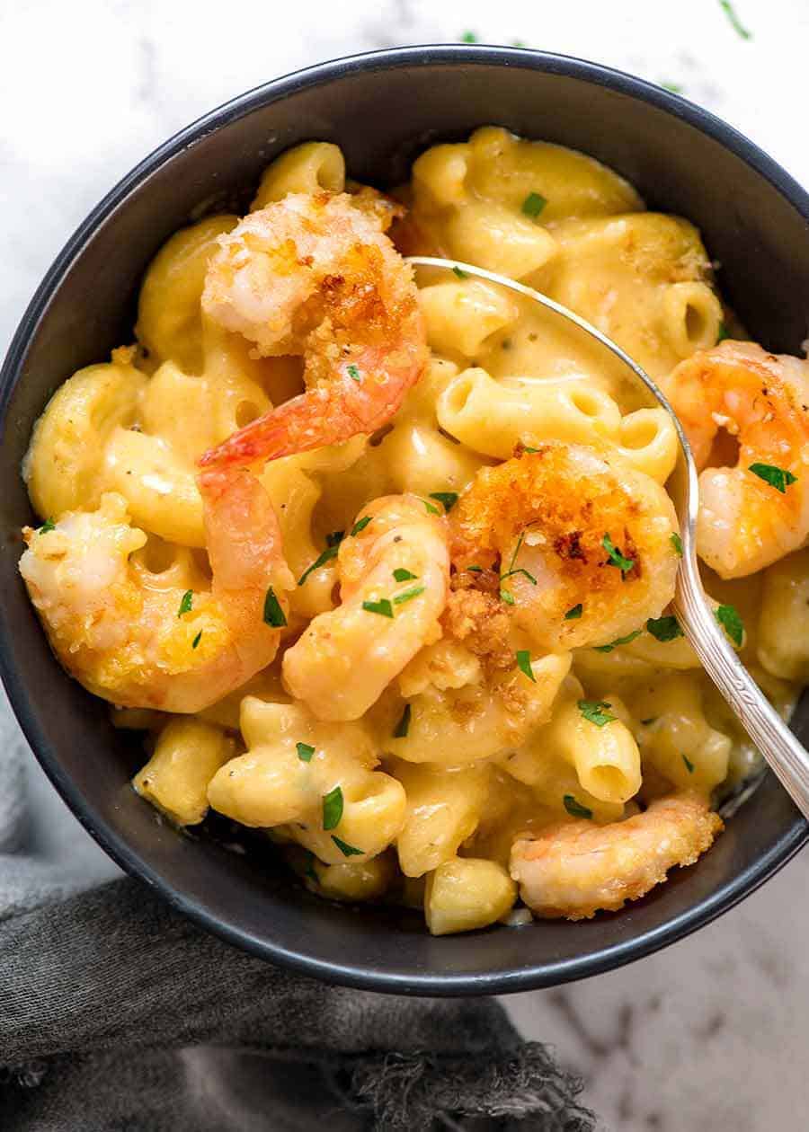 Garlic Shrimp Mac and Cheese in a black bowl, ready to be eaten