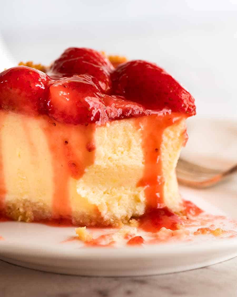 Close up of Strawberry Cheesecake with a bite take out of it