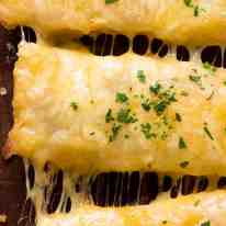 Close up overhead photo of Quick Cheesy Garlic Bread with stretchy cheese, fresh out of the oven