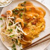 Egg Foo Young - Chinese Omelette on a plate served with rice, ready to be eaten