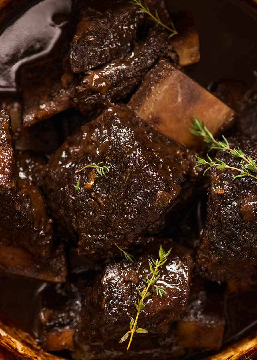 Close up of Slow Braised Beef Short Ribs in Red Wine Sauce in a pot, fresh out of the oven