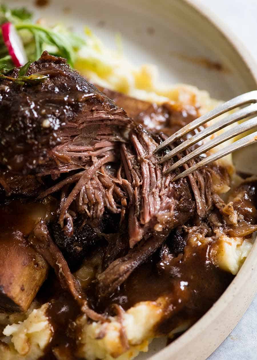 Close up showing the fall apart tender flesh of Slow Braised Beef Short Ribs in Red Wine Sauce