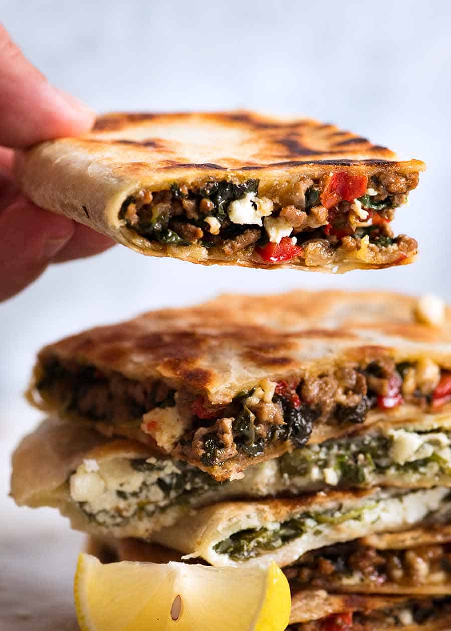 Hand holding beef and spinach gozleme
