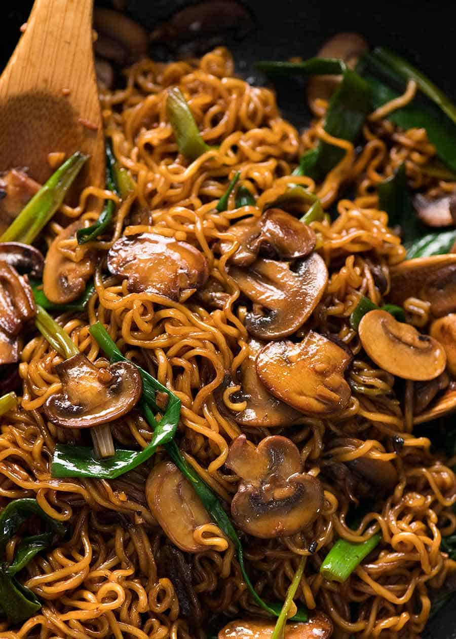 Close up of asian mushroom ramen noodles in a black skillet, fresh from the stove