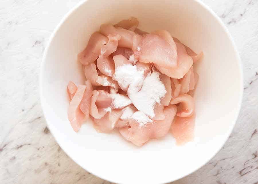 Bowl of raw chicken with baking soda to be tenderised