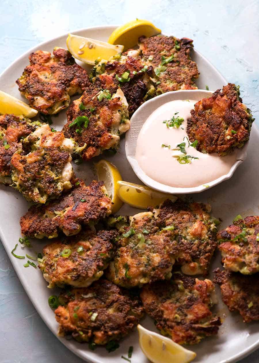Platter full of Broccoli Chicken Fritters with pink dipping sauce