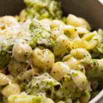 Close up of cheesy broccoli pasta in a bowl, ready to be eaten