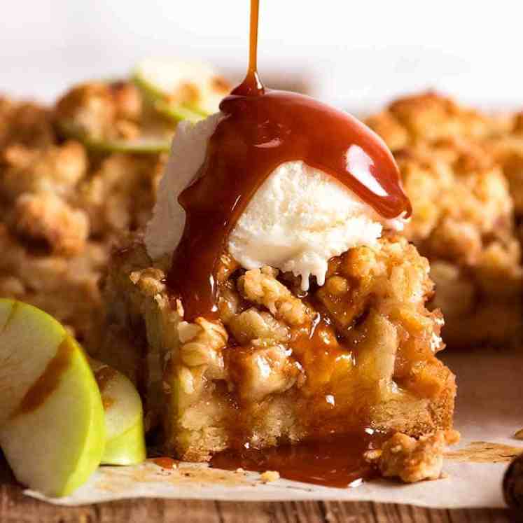 Apple Crumble Bars with crystal  pick  and salted caramel condiment  being drizzled over