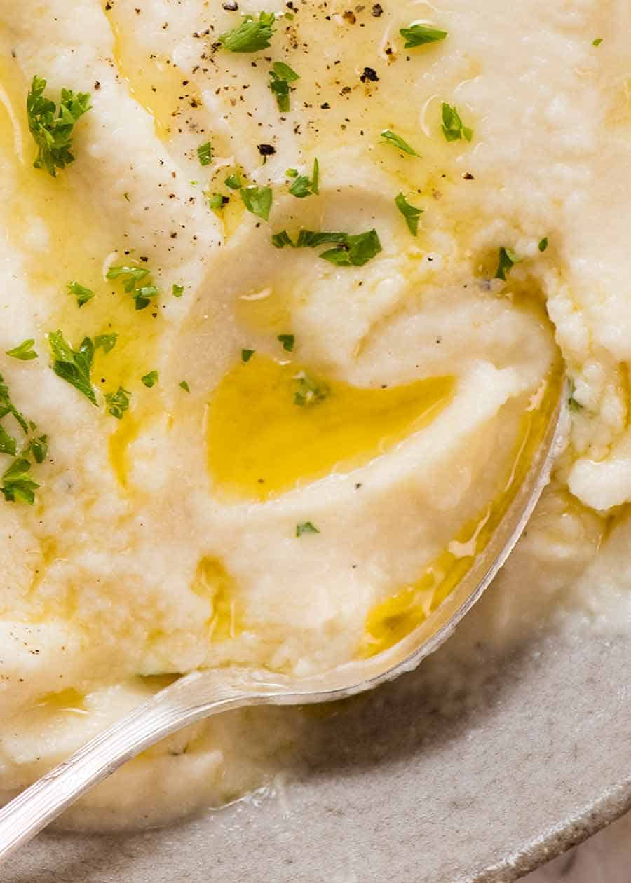 Close up of spoon scooping up buttery Cauliflower Mash